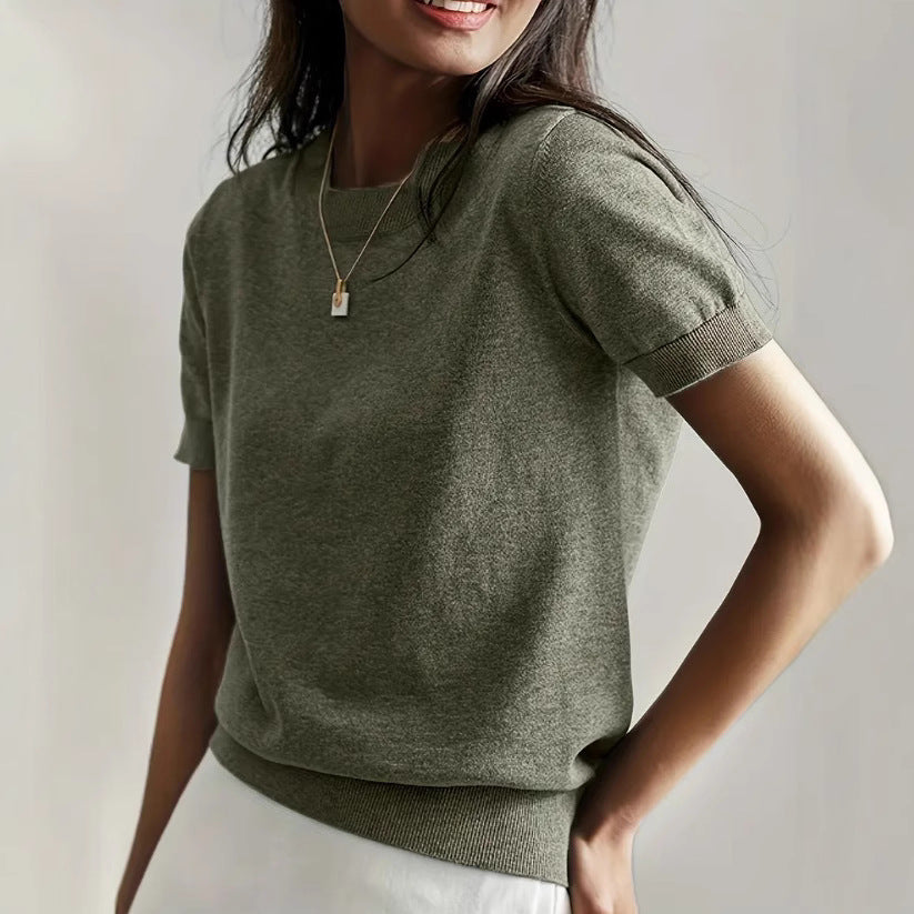 Elegant women's short sleeve knit sweater in soft white for spring & summer fashion.