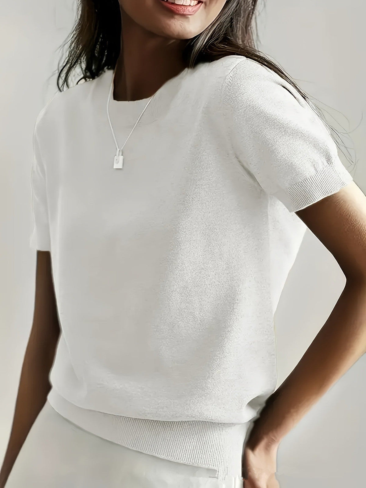 Modern women's short sleeve sweater, a versatile knit top for any occasion.