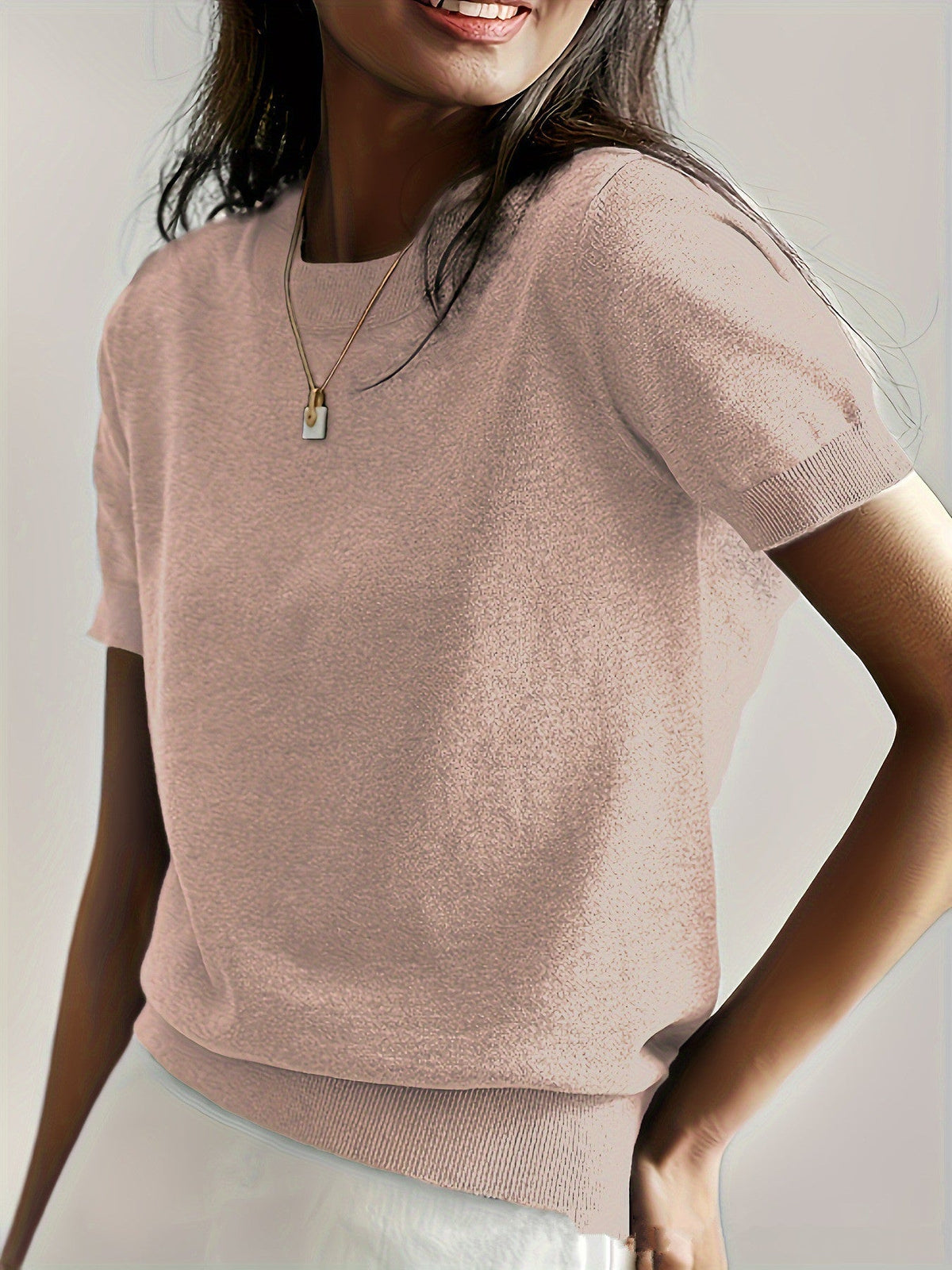 Fashionable women's short sleeve knit sweater, offering both comfort and style.